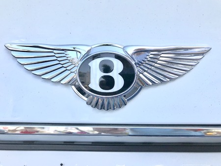 Marbella, Spain - August 10, 2018: Logo of a Bentley car parked inside the famous Puerto Banus. Luxury port where you can take a walk, have a drink and see large and luxurious yachtsのeditorial素材
