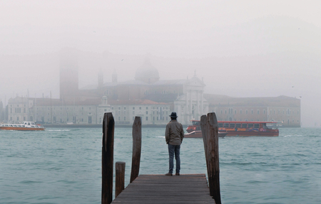 venice italy man standing on the pier near the Grand Canal, cineの写真素材