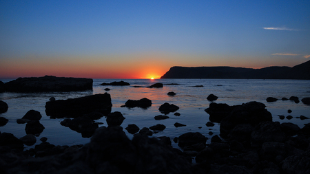 picturesque  stony beach at sunsetの写真素材