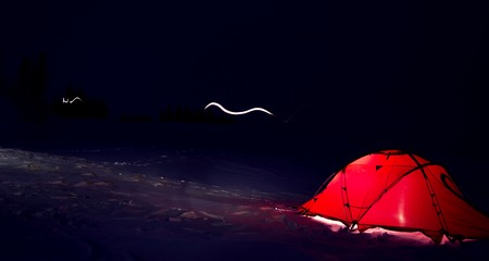 red tent on the snow at night in winter mountainsの写真素材