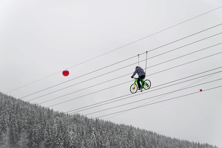 A cyclist rides on a rope. extreme attractionの写真素材