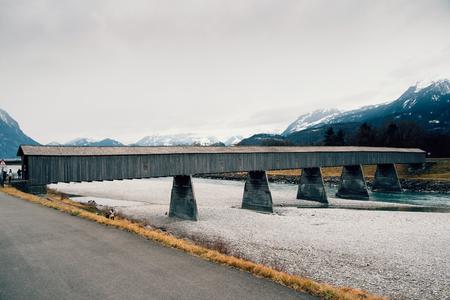 Old wooden bridge crossing the Rhine between Liechtenstein and Switzerlandの写真素材