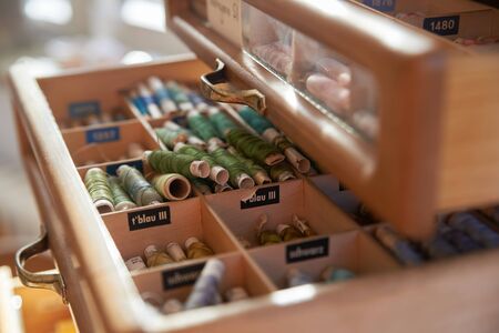 Drawer with different colored threads in it is the windfall for every housewife. Top view.の写真素材