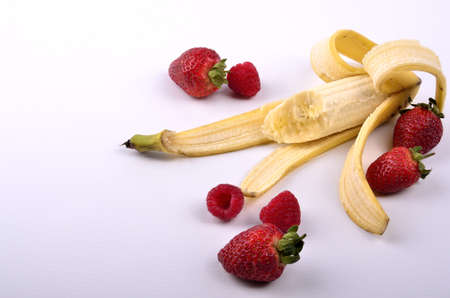 Peeled banana and fruitの写真素材
