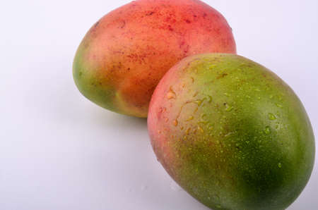 Bright fresh mangoesの写真素材