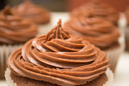 Tight shot on a single chocolate cupcake set against othersの写真素材