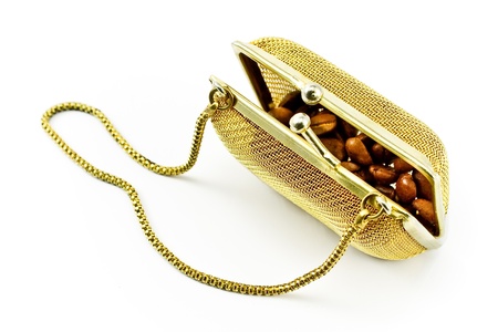 Golden metallic purse with coffee beans isolated on whiteの写真素材