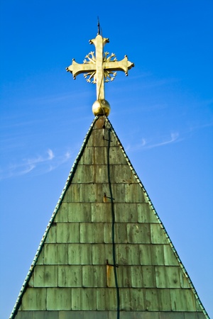 Golden cross on a blue sky backgroundの写真素材