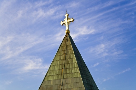Golden cross on a blue sky backgroundの写真素材