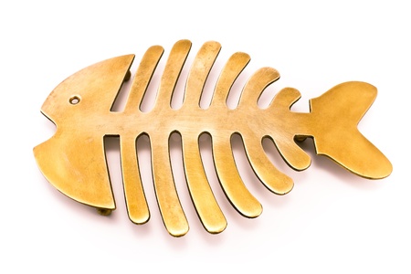 Brass fish mat - kitchen utensil isolated on white