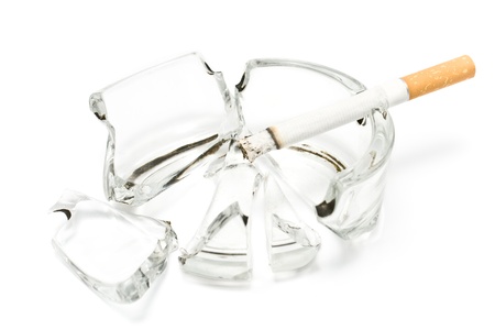 Smoking  cigarette in broken glass ashtrayの写真素材