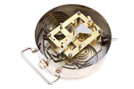 Inside mechanism of old alarm clock isolated on white
