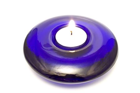 Blue glass candle holder isolated on whiteの写真素材