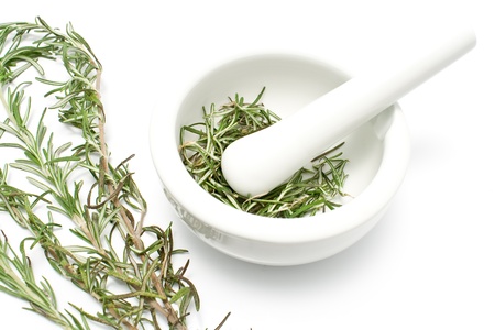 White ceramic mortar and pestle with rosemary isolated on whiteの写真素材