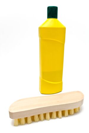 Wooden scrub brush with bottle of cleaning liquid isolated on white の写真素材