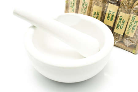 Different spices with porcelain mortar and pestle isolated on whiteの写真素材