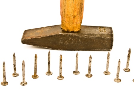 Rusty nails and old hammer isolated on whiteの写真素材