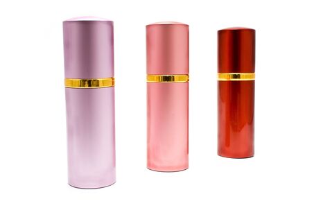 Three colorful spray cans isolated on whiteの写真素材