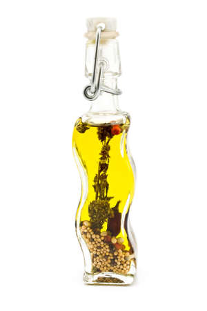Olive oil bottle with spices isolated on whiteの写真素材