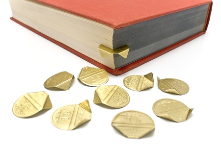 Golden aluminum bookmarks in a book on white の写真素材