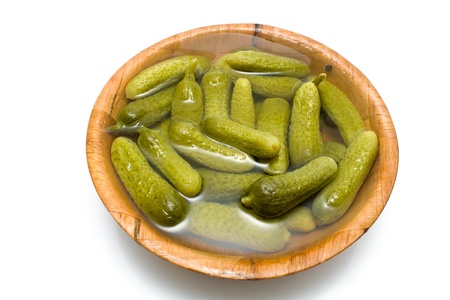 Pickl cucumber in bamboo bowl isolated on whiteの写真素材
