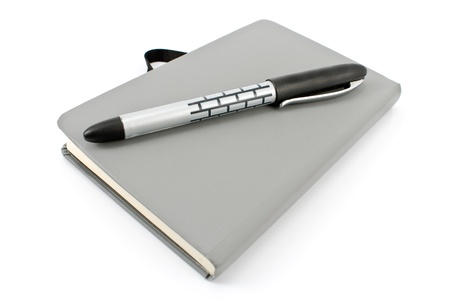 Notepad and pen isolated on whiteの写真素材