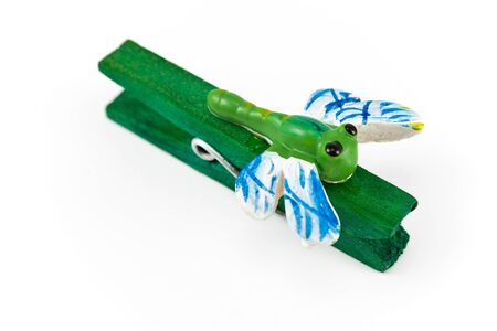 Wooden clothespin decorated with dragonflies on whiteの写真素材
