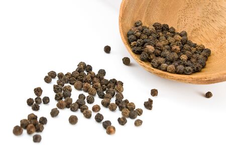 Pepper in wooden spoon isolated on whiteの写真素材