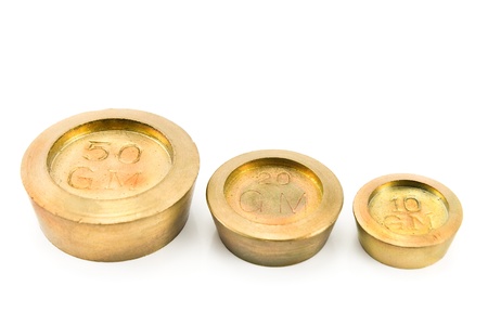 Brass weights of different size isolated on whiteの写真素材