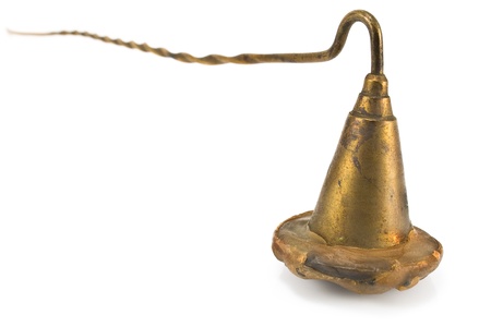 Brass sniffer bell for extinguishing candles isolated on whiteの写真素材