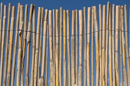 Cane fence texture over blue sky
