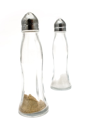 Glass salt and pepper shakers isolated on whiteの写真素材
