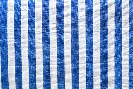 Plastic material in white and blue stripes as backgroundの写真素材