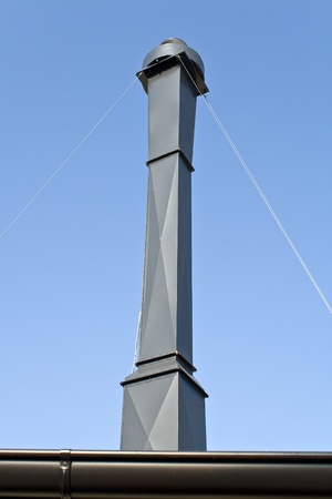 Kitchen chimney over blue skyの写真素材