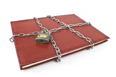 Red notebook with padlock and chain isolated on whiteの写真素材