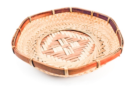 Straw bowl isolated on whiteの写真素材