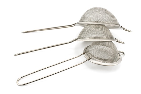 Three colanders isolated on a white