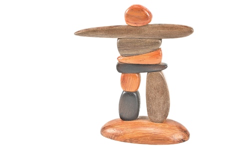 Inukshuk statue isolated on whiteの写真素材