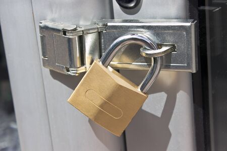 Closed padlock on  a metal doorの写真素材