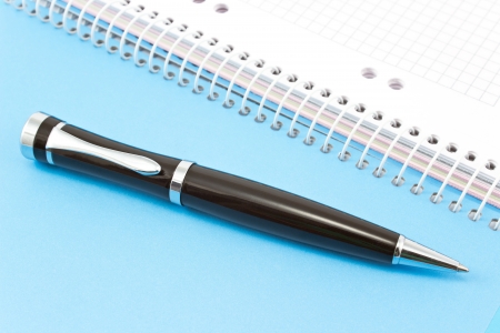 Pen on blue spiral notebook の写真素材