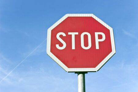 Stop road traffic sign over blue skyの写真素材