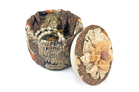 Open old textile jewelry box isolated on whiteの写真素材