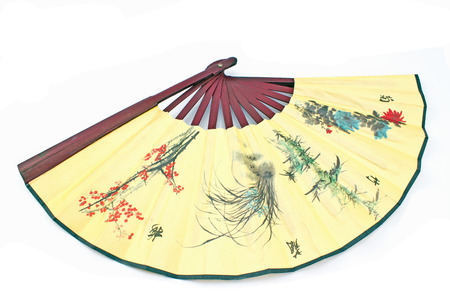 Wooden yellow oriental fan on white backgroundの写真素材