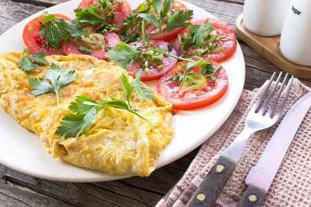 Omelette with vegetables on wooden backgroundの写真素材