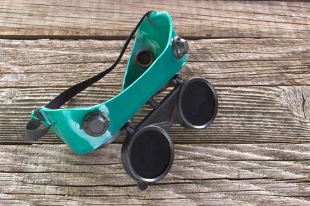 Welding glasses on wooden backgroundの写真素材