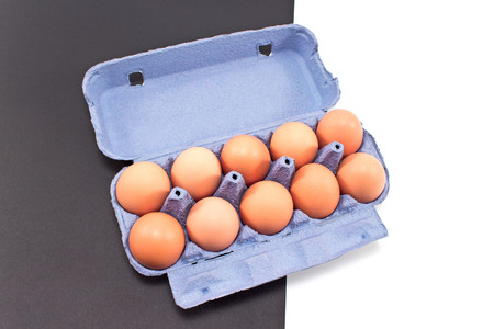 Eggs in cardboard isolated on black whiteの写真素材