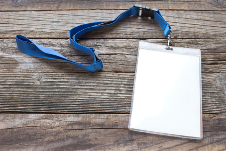 Blank ID card tag on wooden backgroundの写真素材