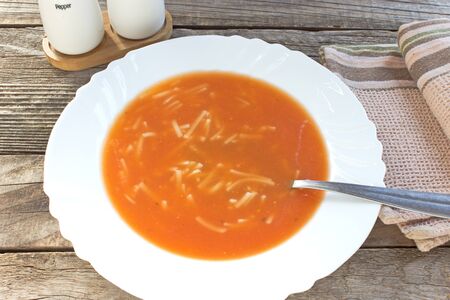 Tomato soup in a white plateの写真素材