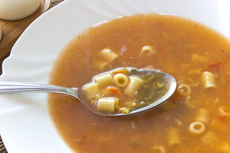 Minestrone soup in plate with spoonの写真素材