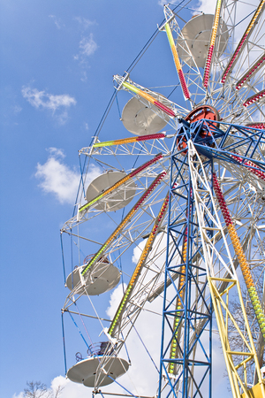 Ferris wheel entertainment over blue skyの写真素材